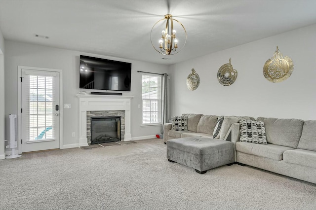 living room featuring a fireplace, carpet, and a notable chandelier