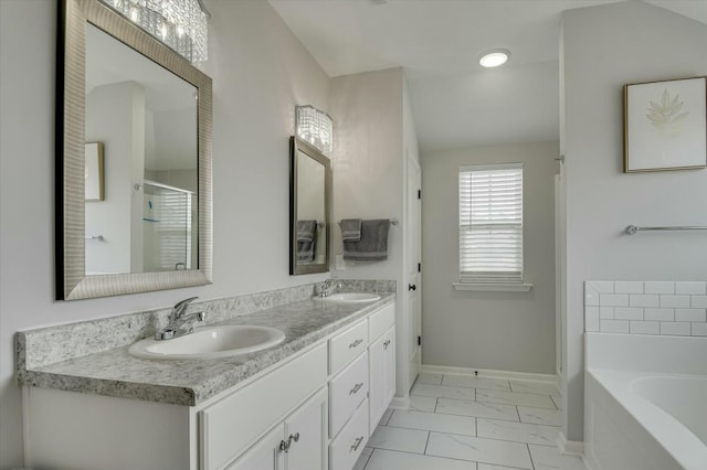 bathroom featuring vanity and a bath