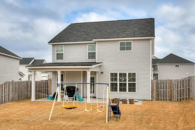 back of property with a patio and a yard