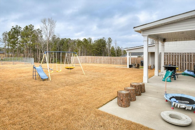 view of play area featuring a patio and a trampoline