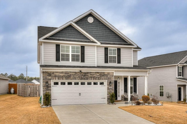 view of front of home with a garage, covered porch, and a front lawn