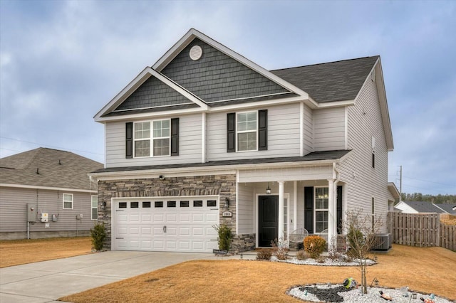 craftsman inspired home with a garage and central air condition unit