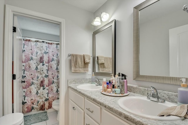 bathroom featuring vanity, toilet, and tile patterned flooring