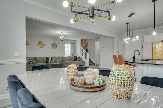 dining space featuring sink and ornamental molding