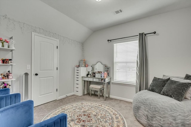 bedroom with lofted ceiling and light colored carpet