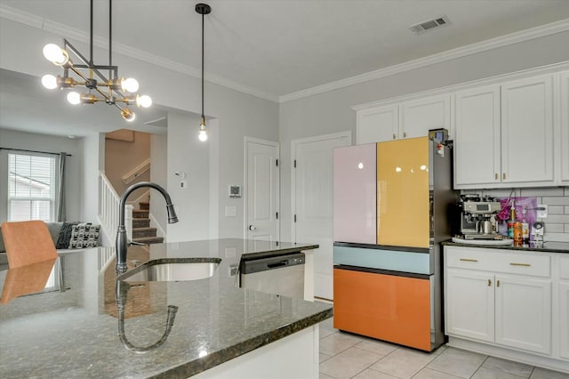 kitchen with white cabinetry, sink, stainless steel dishwasher, and dark stone counters