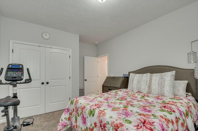 carpeted bedroom featuring a closet and a textured ceiling