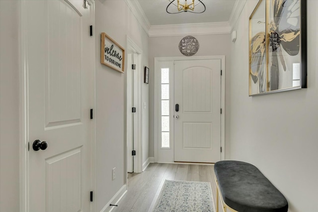 foyer entrance featuring ornamental molding and light hardwood / wood-style floors