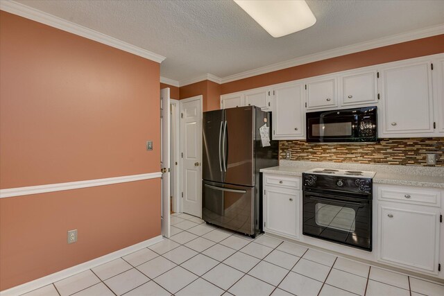 2516 Commons Trce, Augusta, GA 30909 - kitchen with freestanding refrigerator, black microwave, electric stove, white cabinetry, and ornamental molding