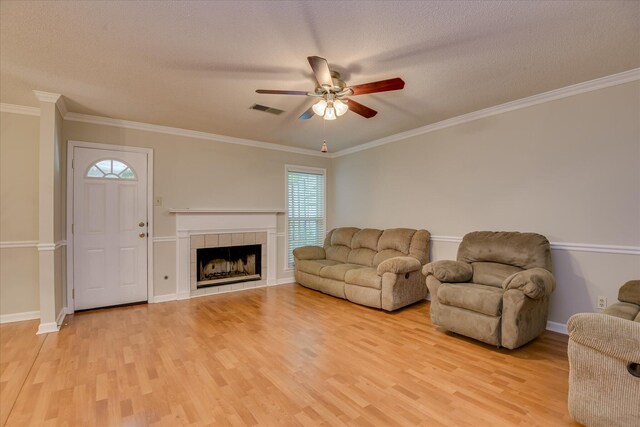 2516 Commons Trce, Augusta, GA 30909 - living room featuring ceiling fan, light wood-style flooring, a fireplace, baseboards, and a textured ceiling