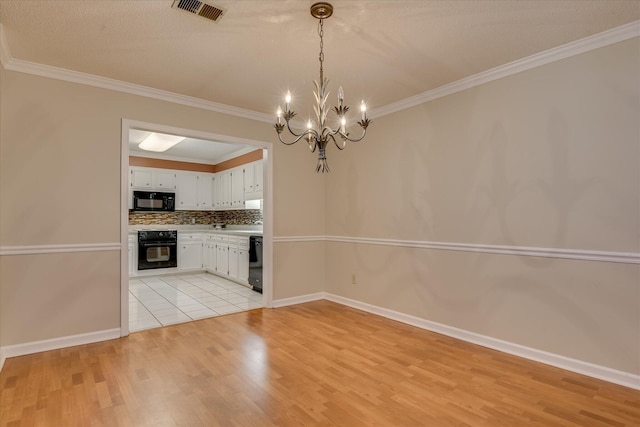 2516 Commons Trce, Augusta, GA 30909 - kitchen with black appliances, light wood-style floors, a chandelier, white cabinets, and ornamental molding