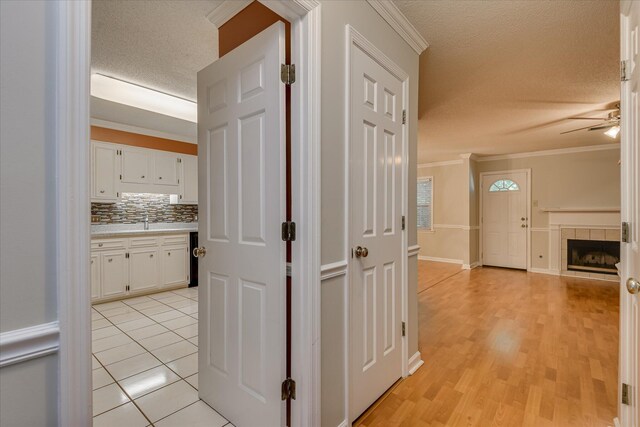 2516 Commons Trce, Augusta, GA 30909 - hall with a textured ceiling, crown molding, a sink, light wood finished floors, and baseboards