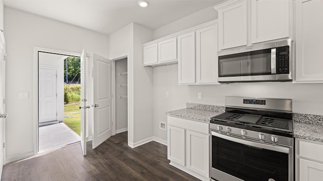 kitchen with white cabinetry, dark wood-style floors, and stainless steel appliances