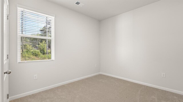 carpeted empty room with baseboards and visible vents