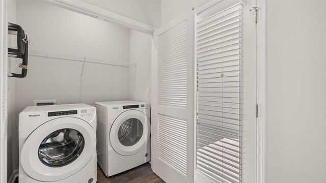 washroom with dark wood-style floors, separate washer and dryer, and laundry area