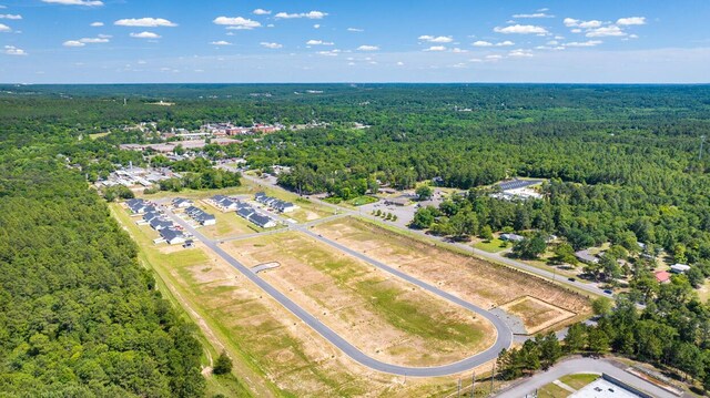 drone / aerial view featuring a forest view