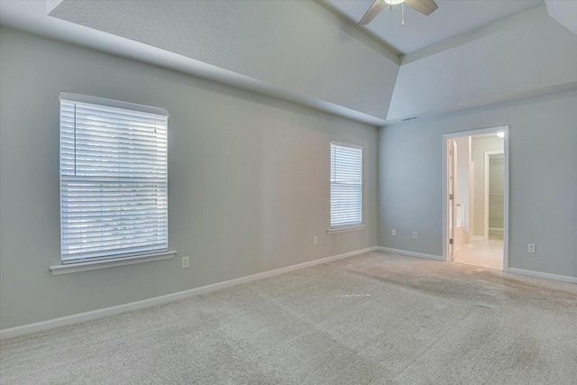 carpeted spare room featuring ceiling fan and lofted ceiling