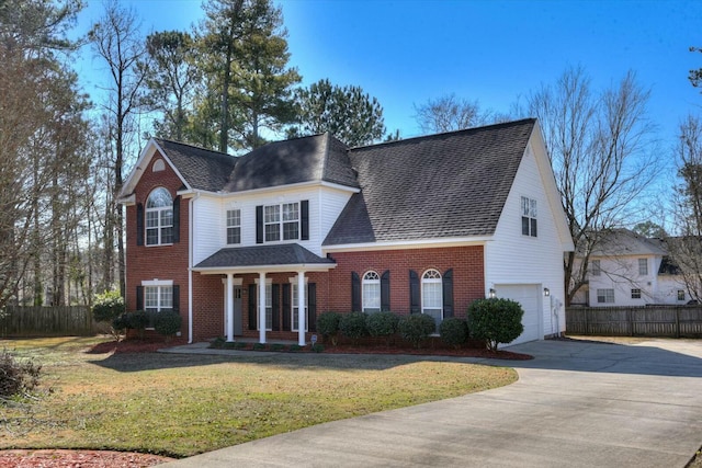 view of front of house featuring a garage and a front lawn