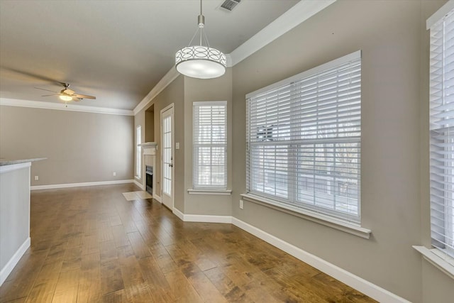 interior space featuring crown molding, ceiling fan, and dark wood-type flooring