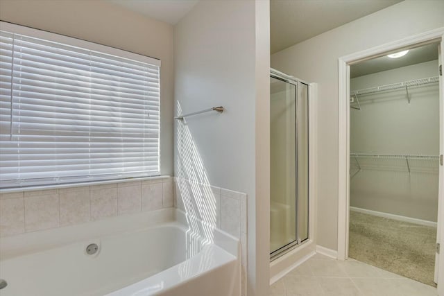 bathroom with tile patterned floors and independent shower and bath