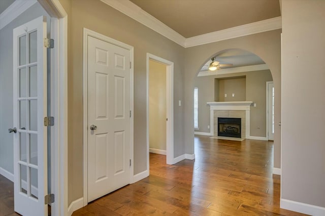 hallway with wood-type flooring and crown molding