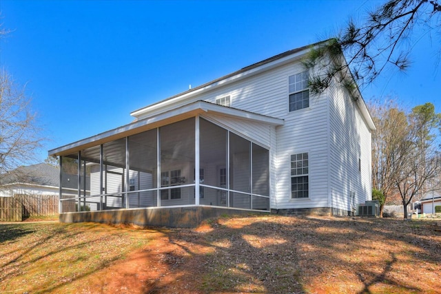 back of property featuring a sunroom and central air condition unit