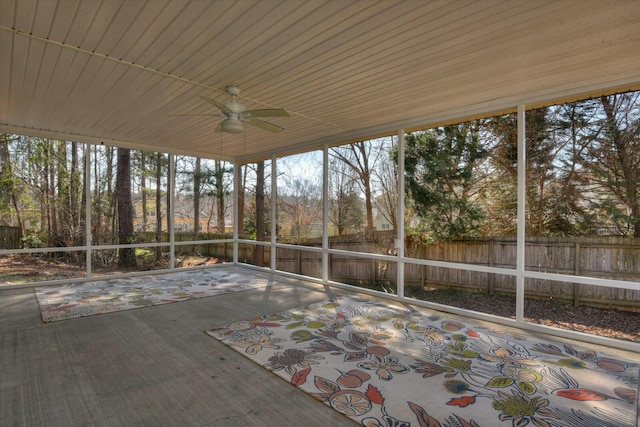 unfurnished sunroom featuring ceiling fan