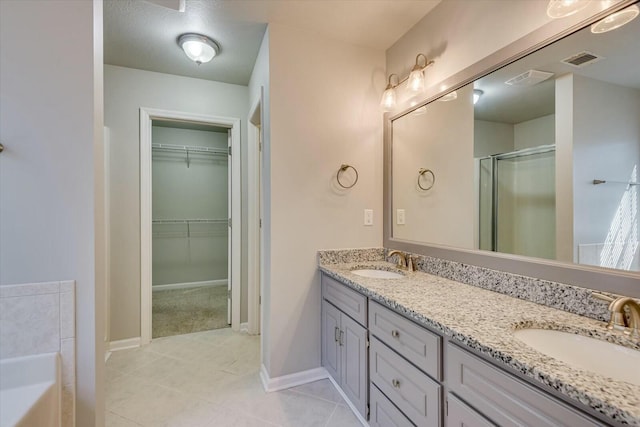 bathroom featuring vanity, tile patterned floors, and independent shower and bath