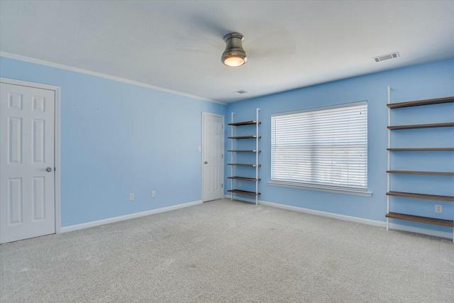 interior space featuring crown molding and light carpet