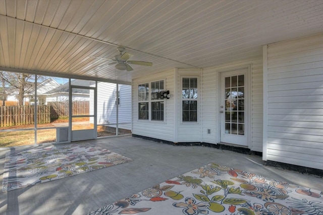 unfurnished sunroom featuring ceiling fan