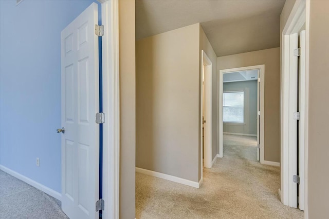 hallway featuring light carpet