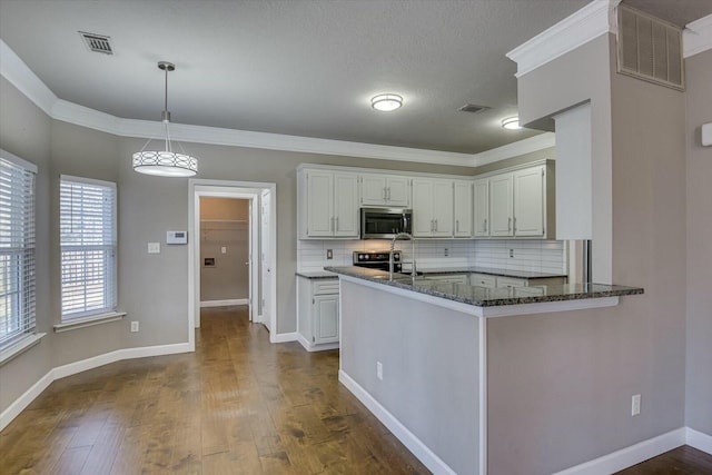 kitchen with tasteful backsplash, decorative light fixtures, dark hardwood / wood-style floors, kitchen peninsula, and white cabinets