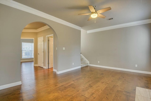 empty room with hardwood / wood-style flooring, ornamental molding, and ceiling fan