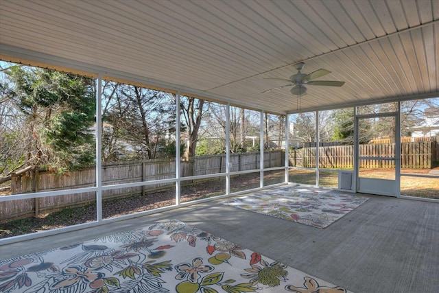 unfurnished sunroom with ceiling fan