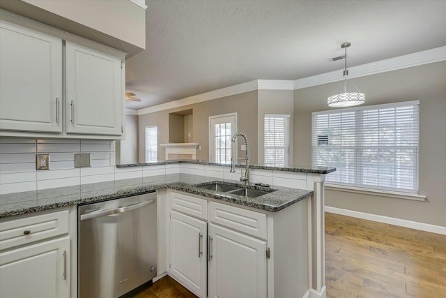 kitchen featuring sink, crown molding, white cabinetry, stainless steel dishwasher, and kitchen peninsula