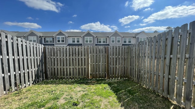 view of yard with a fenced backyard and a residential view