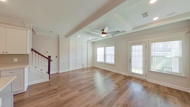 interior space featuring stairs, light wood finished floors, beam ceiling, and baseboards