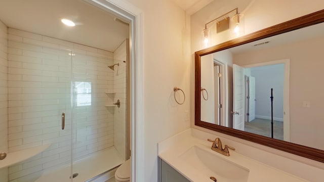 bathroom with toilet, a shower stall, visible vents, and vanity