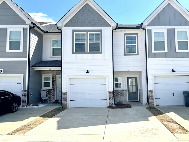 155 Canton Park Ave, Evans, GA 30809 - view of property featuring a garage, concrete driveway, brick siding, and board and batten siding