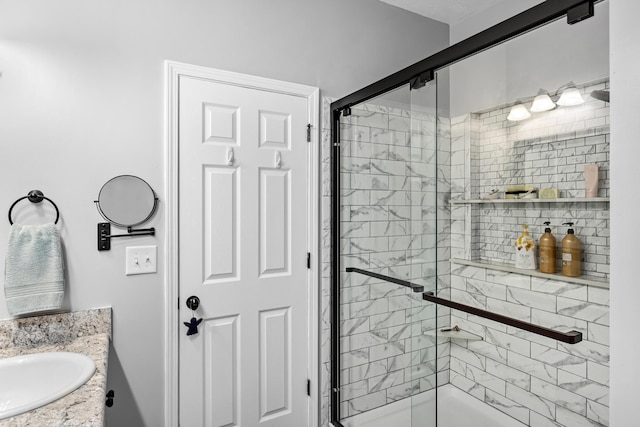 bathroom with walk in shower and vanity