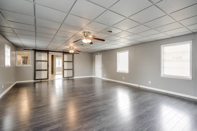 2705 S Vernon Dr, Augusta, GA 30906 - unfurnished room with a barn door, ceiling fan, healthy amount of natural light, wood finished floors, and a drop ceiling