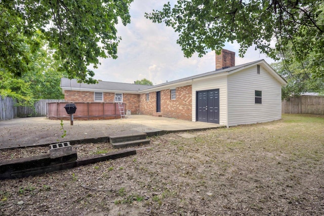 2705 S Vernon Dr, Augusta, GA 30906 - rear view of house with a patio area, a fenced backyard, a chimney, and brick siding