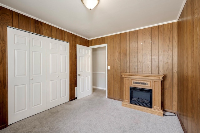 2705 S Vernon Dr, Augusta, GA 30906 - unfurnished living room with carpet flooring, wood walls, a fireplace, and crown molding