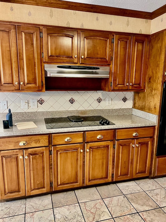 kitchen featuring brown cabinets, black electric stovetop, light marble finish floors, and tasteful backsplash