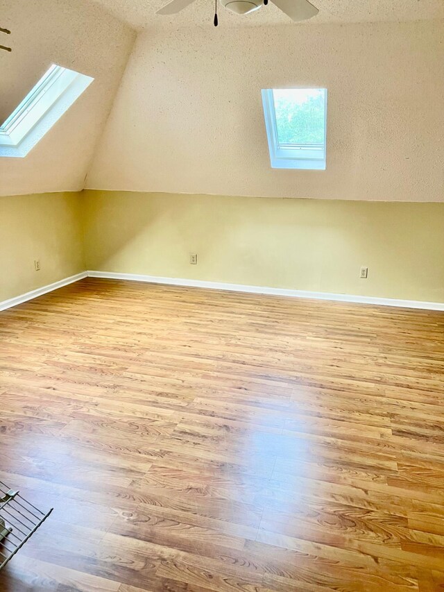 4161 Quail Springs Cir, Martinez, GA 30907 - bonus room with a skylight, wood finished floors, lofted ceiling, ceiling fan, and baseboards