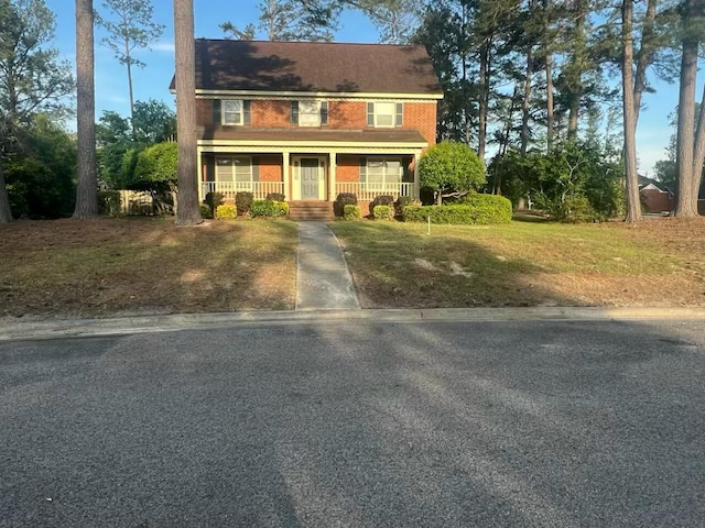 colonial inspired home featuring a porch