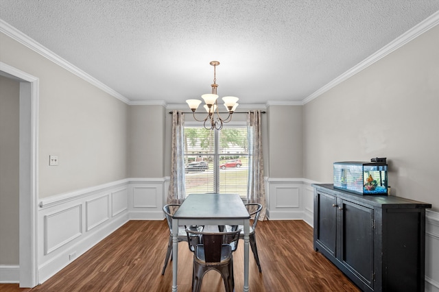 914 Deercrest Cir, Evans, GA 30809 - dining room featuring a chandelier, dark wood-style flooring, a textured ceiling, a wainscoted wall, and crown molding