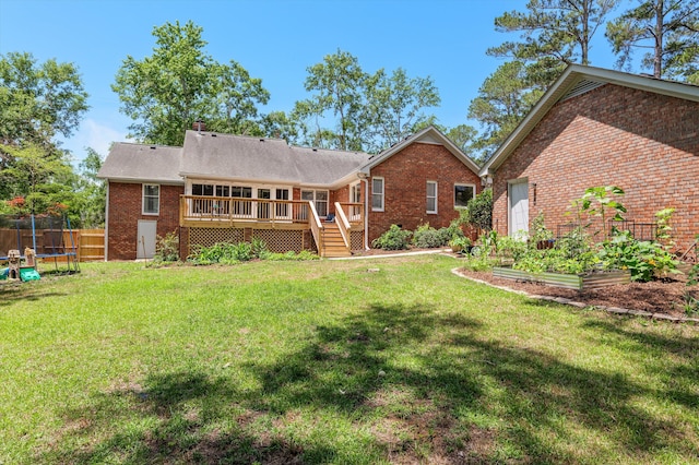 914 Deercrest Cir, Evans, GA 30809 - rear view of house with a trampoline, a garden, a wooden deck, brick siding, and stairs