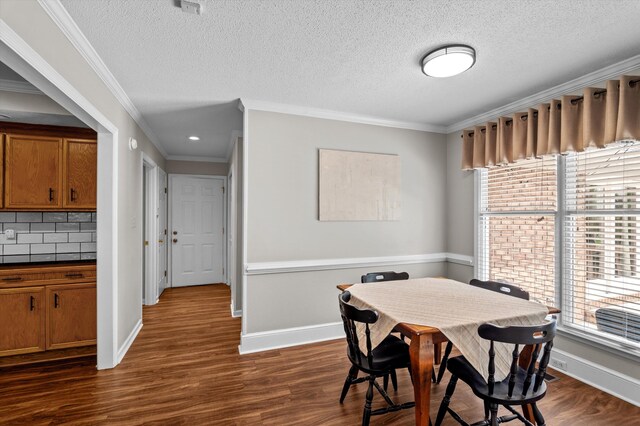 914 Deercrest Cir, Evans, GA 30809 - dining area featuring plenty of natural light, dark wood-style flooring, ornamental molding, baseboards, and a textured ceiling