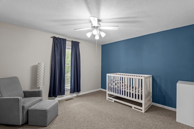 914 Deercrest Cir, Evans, GA 30809 - bedroom with carpet floors, a textured ceiling, a nursery area, ceiling fan, and baseboards